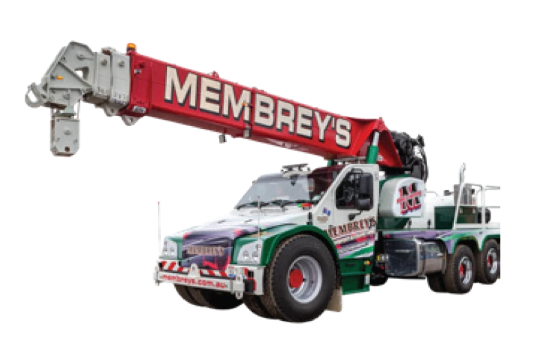 A large tow truck crane with “Membrey's” written on the red crane arm, featuring multi-colored designs and six wheels, designed for heavy-duty lifting and towing.