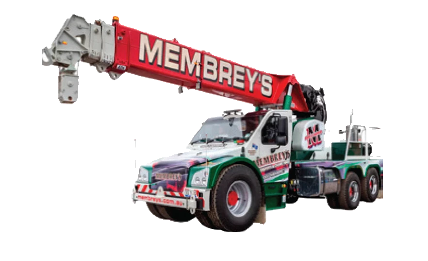 A large green, white, and red mobile crane truck with "MEMBREY'S" written on the extended boom arm, featuring multiple wheels and stabilizers.