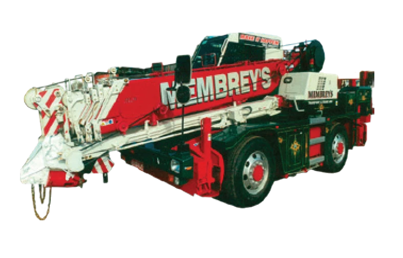 A red and white heavy-duty tow truck with "Membrey's" branding on the side, featuring an extended hydraulic boom and large wheels, designed for vehicle recovery and transport.